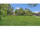 Spacious backyard featuring lush green grass, a swing set, and mature trees for shade at 250 Hickory Ave, Orange City, FL 32763