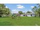 Spacious backyard featuring lush green grass, and a swing set at 250 Hickory Ave, Orange City, FL 32763