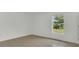 Bright bedroom featuring tile floors, neutral walls, and natural light from the window at 250 Hickory Ave, Orange City, FL 32763