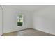 Bright bedroom featuring tile floors, neutral walls, and natural light from the window at 250 Hickory Ave, Orange City, FL 32763