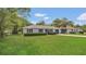 Charming single-story home featuring a lush green lawn and beautiful landscaping enhancing curb appeal at 250 Hickory Ave, Orange City, FL 32763
