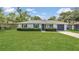 Well-maintained single-story house with a neatly manicured front lawn, dark shutters, and a one car garage at 250 Hickory Ave, Orange City, FL 32763