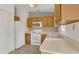 Efficient kitchen featuring wooden cabinets, essential appliances, and a practical layout for meal preparation at 250 Hickory Ave, Orange City, FL 32763