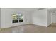 Bright living room with tile flooring, natural light from a large window, and neutral paint at 250 Hickory Ave, Orange City, FL 32763