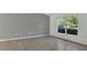 Open living room with tile floors and a large window offering ample natural light and neighborhood views at 250 Hickory Ave, Orange City, FL 32763