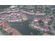 An aerial view of a community featuring buildings and ponds at 2536 Woodgate Blvd # 202, Orlando, FL 32822