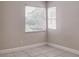 This bedroom features tiled floors, baseboard trim, and natural light at 2536 Woodgate Blvd # 202, Orlando, FL 32822