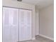 This bedroom showcases bi-fold doors to the closet at 2536 Woodgate Blvd # 202, Orlando, FL 32822