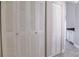 Hallway features full-length white closet doors at 2536 Woodgate Blvd # 202, Orlando, FL 32822