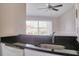 The kitchen's breakfast bar has granite countertop and stainless steel faucet with a window view at 2536 Woodgate Blvd # 202, Orlando, FL 32822