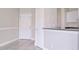 Living room showing breakfast bar, white doors, neutral walls and tiled floors at 2536 Woodgate Blvd # 202, Orlando, FL 32822