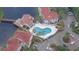 Aerial view of a community pool surrounded by palm trees and buildings at 2536 Woodgate Blvd # 202, Orlando, FL 32822