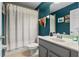 Full bathroom with tub and shower features dark blue walls and gray vanity at 2762 Pepper Ln, Orlando, FL 32812