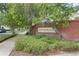 Welcoming community entrance with brick signage, lush green landscaping, and tree-lined streets at 2762 Pepper Ln, Orlando, FL 32812