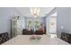Open dining room featuring a modern light fixture and views into the living area at 2762 Pepper Ln, Orlando, FL 32812