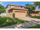 Two-story home with a two-car garage, brick-paved driveway, manicured lawn and neutral toned exterior at 2762 Pepper Ln, Orlando, FL 32812