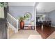 Inviting foyer with tile flooring, stairs, a decorative bench, and a mirror at 2762 Pepper Ln, Orlando, FL 32812