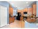 Well-lit kitchen featuring wooden cabinets, granite countertops, and stainless steel appliances at 2762 Pepper Ln, Orlando, FL 32812