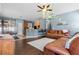 Cozy living room with a leather sofa, hardwood floors, and an open concept kitchen at 2762 Pepper Ln, Orlando, FL 32812
