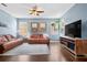 Bright living room featuring hardwood floors, a comfortable seating area, and natural light at 2762 Pepper Ln, Orlando, FL 32812