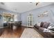 Open concept living room featuring hardwood floors, comfortable seating, and natural light at 2762 Pepper Ln, Orlando, FL 32812