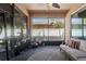 Cozy screened patio area showcasing ample sunlight, neutral tones, stylish furniture, and various potted plants at 2762 Pepper Ln, Orlando, FL 32812