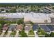 An aerial view of houses near large retail buildings with ample parking and roadway access at 293 Drosdick Dr, Casselberry, FL 32707