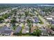 Residential neighborhood aerial view with mature trees, well-manicured lawns, and proximity to a thoroughfare at 293 Drosdick Dr, Casselberry, FL 32707