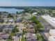 Aerial view of a residential neighborhood with a lake, tennis courts, and commercial area at 293 Drosdick Dr, Casselberry, FL 32707