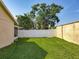 Lush backyard with green lawn and privacy fence, offering ample space for recreation and relaxation at 293 Drosdick Dr, Casselberry, FL 32707
