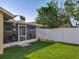 Serene backyard featuring a well-maintained lawn and a screened patio, perfect for outdoor enjoyment at 293 Drosdick Dr, Casselberry, FL 32707