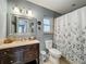 Bathroom with a large mirror, under-mount sink vanity, and a shower with a decorative shower curtain at 293 Drosdick Dr, Casselberry, FL 32707