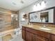 Updated bathroom with double sinks, granite countertops, and a walk-in shower with glass doors at 293 Drosdick Dr, Casselberry, FL 32707
