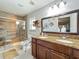 Accessible bathroom with double sinks, granite countertops and a walk-in shower with seating at 293 Drosdick Dr, Casselberry, FL 32707