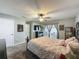 Bedroom features a TV, ceiling fan, patio door, and refined decorations at 293 Drosdick Dr, Casselberry, FL 32707