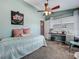 Bedroom with ceiling fan, desk by window, comfortable bed, and cool, calming paint at 293 Drosdick Dr, Casselberry, FL 32707
