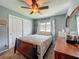 Bedroom with dresser, closet and comfortable bed with ceiling fan at 293 Drosdick Dr, Casselberry, FL 32707
