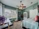 Cozy bedroom featuring a ceiling fan, a desk area by the bright window, and a charming wardrobe at 293 Drosdick Dr, Casselberry, FL 32707
