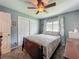 Well-lit bedroom with large closet and view to a sunny window and a traditional wood dresser at 293 Drosdick Dr, Casselberry, FL 32707