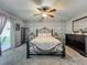 Bedroom with brick feature wall, ceiling fan, door to patio and comfortable bed at 293 Drosdick Dr, Casselberry, FL 32707