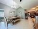 Lovely dining room showcasing a vaulted ceiling, tile floors and an adjacent kitchen area at 293 Drosdick Dr, Casselberry, FL 32707