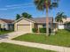 Charming single-story home with well-maintained lawn, stone accents, and an attached garage at 293 Drosdick Dr, Casselberry, FL 32707