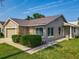 Well-kept home with stone facade, trimmed bushes, green lawn, and a welcoming walkway at 293 Drosdick Dr, Casselberry, FL 32707