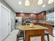 Kitchen island with barstool seating is positioned in front of a chef's kitchen area at 293 Drosdick Dr, Casselberry, FL 32707