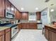 Well-equipped kitchen with stainless steel appliances, granite countertops, and dark wood cabinets at 293 Drosdick Dr, Casselberry, FL 32707