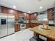 Well-equipped kitchen with stainless steel appliances, granite countertops, and custom cabinets at 293 Drosdick Dr, Casselberry, FL 32707