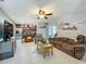 Open concept living area with a cozy sofa and open view to the kitchen, perfect for entertaining guests at 293 Drosdick Dr, Casselberry, FL 32707