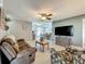 Inviting living room with ceiling fan, tile floors, and a smooth connection to the dining area at 293 Drosdick Dr, Casselberry, FL 32707
