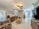 Comfortable living room boasts neutral walls, ceramic tile floors, and a ceiling fan at 293 Drosdick Dr, Casselberry, FL 32707