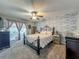 Comfortable bedroom with a decorative accent wall, ceiling fan and outdoor access to the lanai at 293 Drosdick Dr, Casselberry, FL 32707